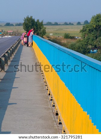 Odessa, Ukraine - 5 September 2015: The bridge with the road and fence with Ukrainian national flag near the border