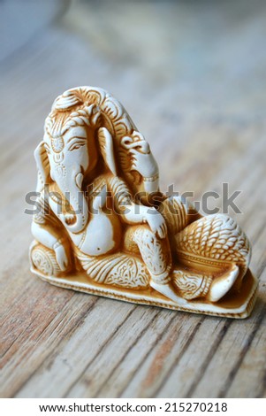 Indian god Ganesha (Ganapati) on wooden background