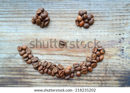 Smiling face made from coffee beans