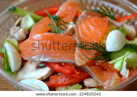 Healthy salad with salmon and quail eggs