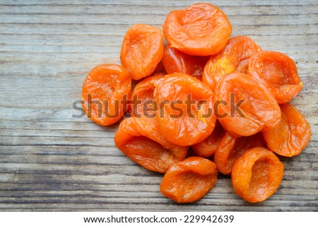 Dried apricots on wooden table