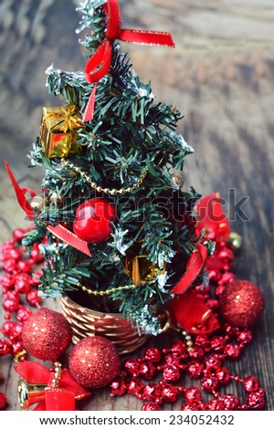 Little Christmas tree with red and golden decorations