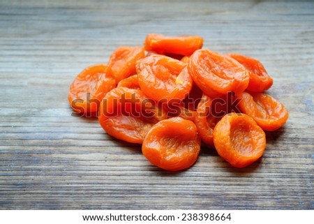 Dried apricots on wooden table