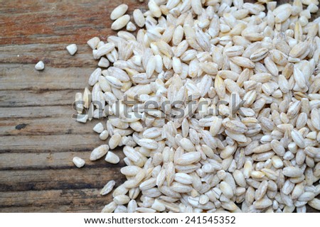 Pearl barley grains on wooden table