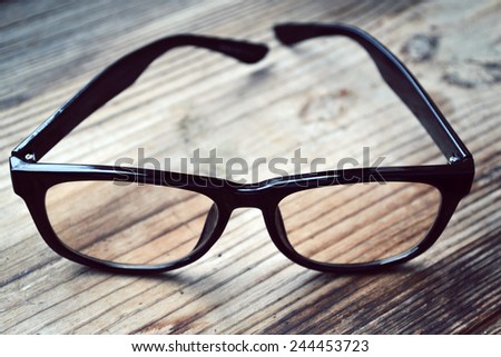 Black vintage reading glasses for computer on wooden table