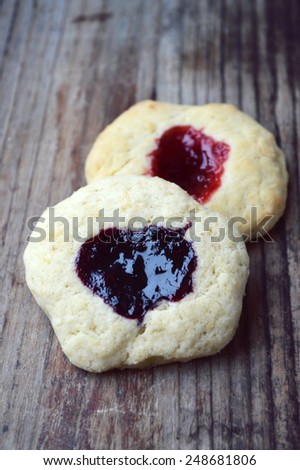 Homemade cookies with jam on wooden table