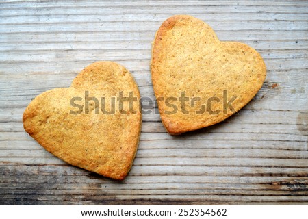 Gingerbread cookies in shape of heart on wooden table
