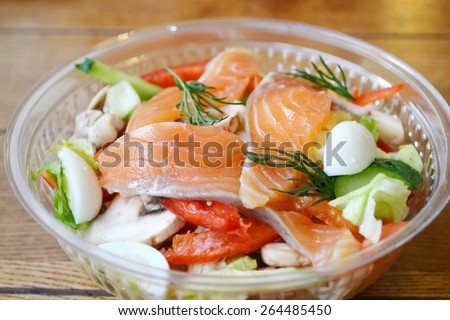 Healthy salad with salmon and quail eggs