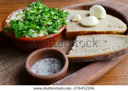 Traditional Ukrainian snack made of black bread, garlic and a topping of lard and parsley