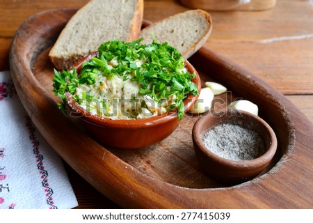 Traditional Ukrainian snack made of black bread, garlic and a topping of lard and parsley
