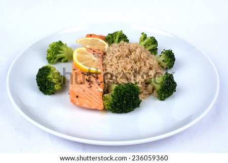 A Plate With Broccoli, Lemon, Rice, Broccoli And Salomon