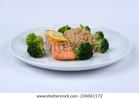 A Plate With Salomon, Lemon, Broccoli And Rice
