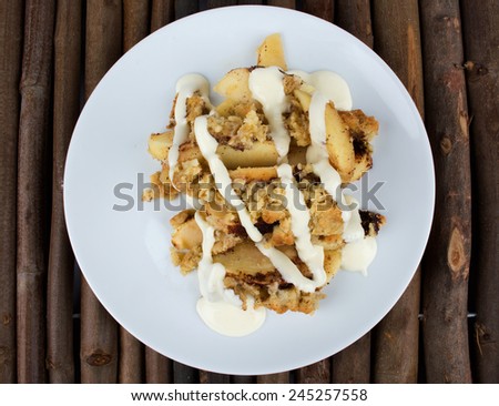 Apple Pie On A White Plate And Wooden Background With Vanilla Sauce