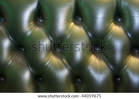 Gentlemen\'s club for wealthy men, leather Chesterfield sofa back.