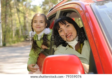 women and girl in auto