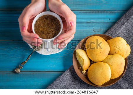 Photo of Woman Hold Coffee in vintage mug in hands with grunge spoon and hand made cookies