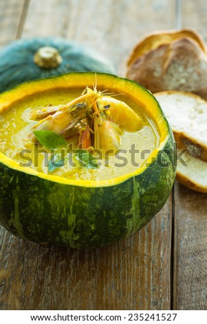 Pumpkin soup in a pumpkin with bread