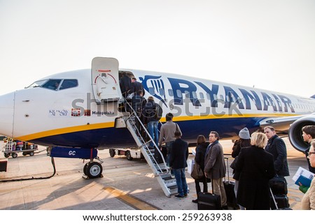 BOLOGNA, ITALY - March 2, 2015: Passengers boarding Ryanair Jet airplane in Bologna airport. Bologna, Italy.