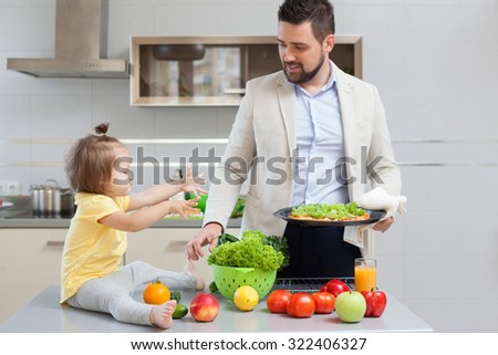 Father and child preparing pizza together