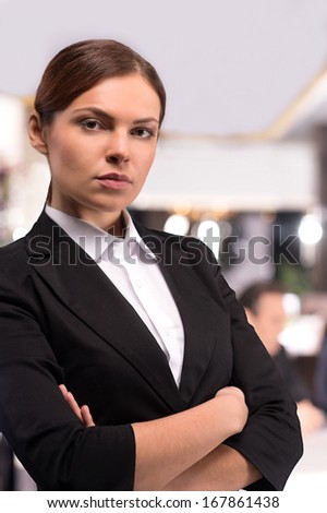 Confident business lady. Beautiful young woman in formalwear keeping arms crossed and looking at camera
