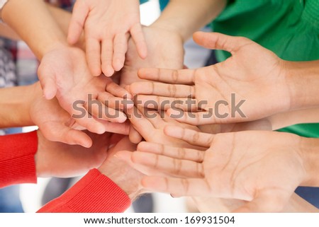We are all people. Top view of people holding their palms together