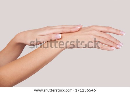 Hands care. Close-up of beautiful female hands isolated on grey