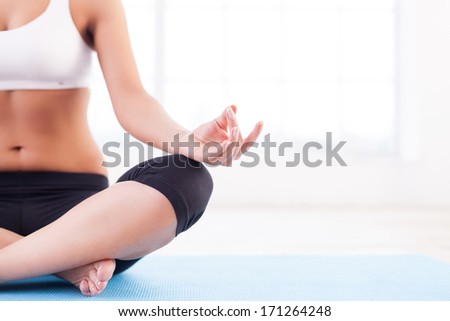 Total relaxation. Cropped image of women meditating while sitting in lotus position