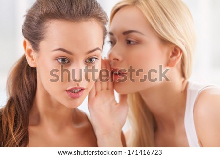 No way news. Beautiful young blond hair woman whispering something to her surprised friend