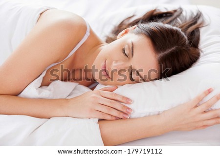 Woman sleeping. Beautiful young woman sleeping while lying in bed