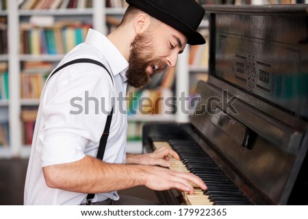 He got creative soul. Handsome young bearded men playing piano and singing