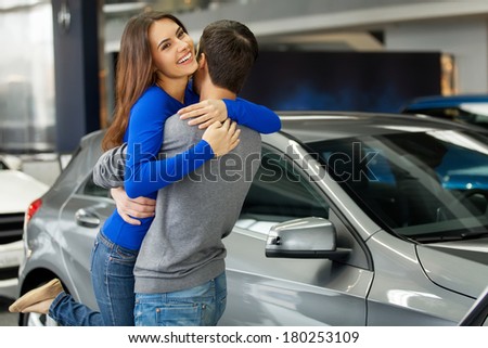 Thank you dear! Young beautiful woman hugging her boyfriend thanks for the new car