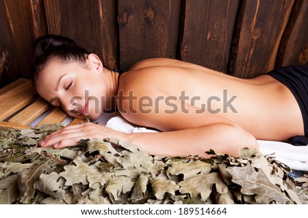Beauty relaxing in bathhouse. Beautiful young woman relaxing in bathhouse