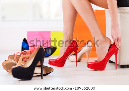 Choosing the perfect pair. Cropped image of young woman choosing shoes in a shoe store