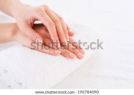 Smooth skin. Close-up of beautiful female hands on the towel
