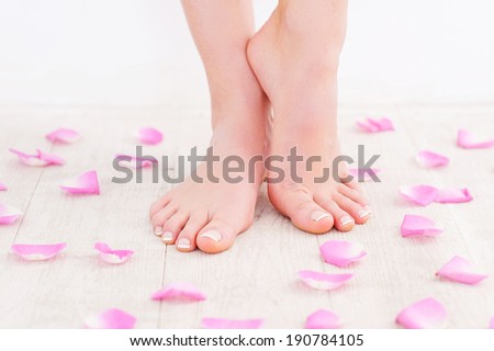 Fresh and clean feet. Cropped image of beautiful female feet on hardwood floor