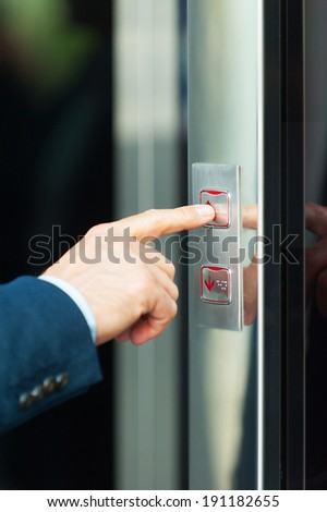 He is going up. Cropped image of male hand pushing the elevator button