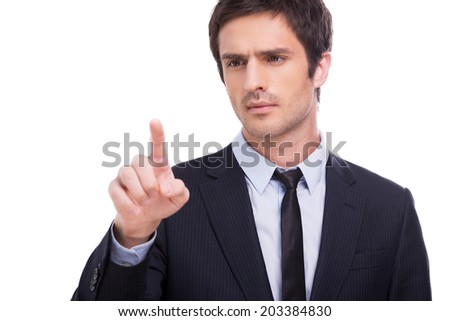 Working on transparent wipe board. Handsome young man in shirt and tie touching transparent wipe board while standing isolated on white background