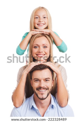 We are family! Happy family of three leaning at each other head and smiling while standing against white background
