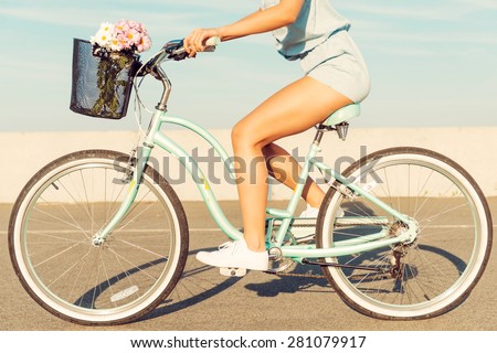What a beautiful scenery! Smiling young couple riding on bicycle while man pointing away