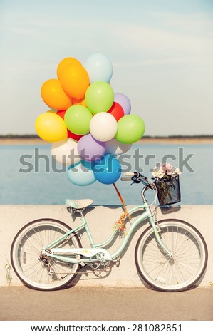 Summer bike. Picture of vintage bicycle with balloons and flowers in basket
