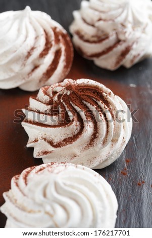 Vanilla Meringue with cocoa powder on black background