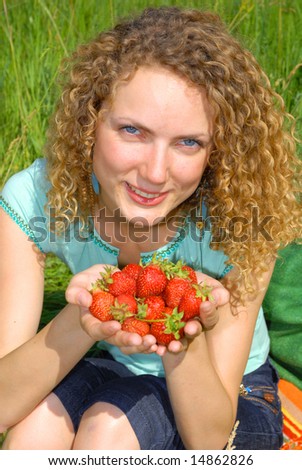 beautiful girl with strawberry in hands