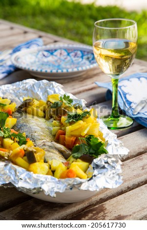 Baked sea bass with vegetables on the festive table