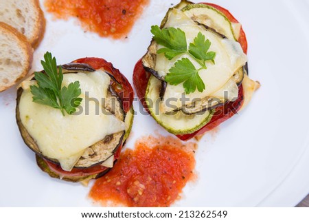 Baked vegetables with melting cheese - top view