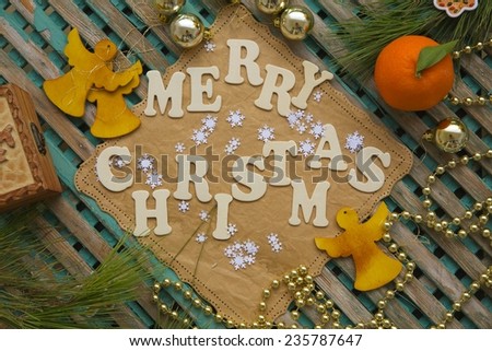Winter holidays background on a wooden surface with inscription:\