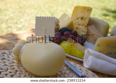 Italian cheese- caciocavallo on the woven surface with a label. Free space for a text