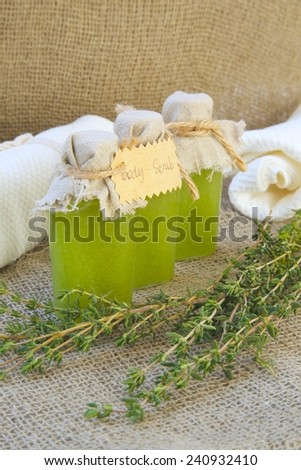 Body scrub with thyme essential oil. Thyme twigs in the background