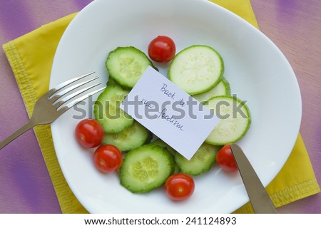 Message on the plate with raw vegetables: \