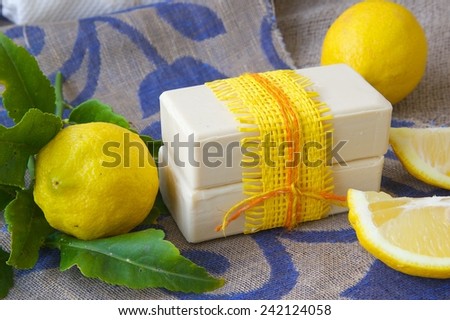Lemon soap. Fresh lemon fruit in the background