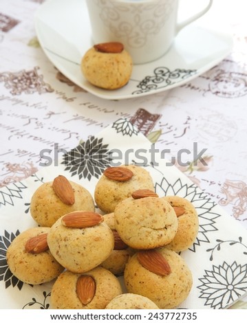 Homemade fitness biscuits with almond pasta, sesame seeds,honey and without flour on a round white plate.